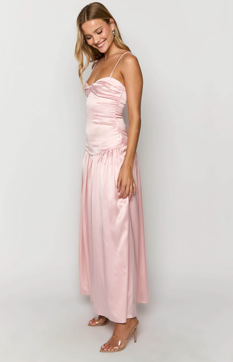 Side view of a pink satin maxi dress with a knotted sweetheart neckline and ruched bodice, flowing into a gathered skirt