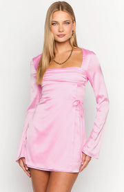 Front view of a pink satin mini dress with a ruched square neckline and wrap tie detail