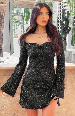 Close-up of the black sequin mini dress showing the dense sequin texture and sweetheart neckline