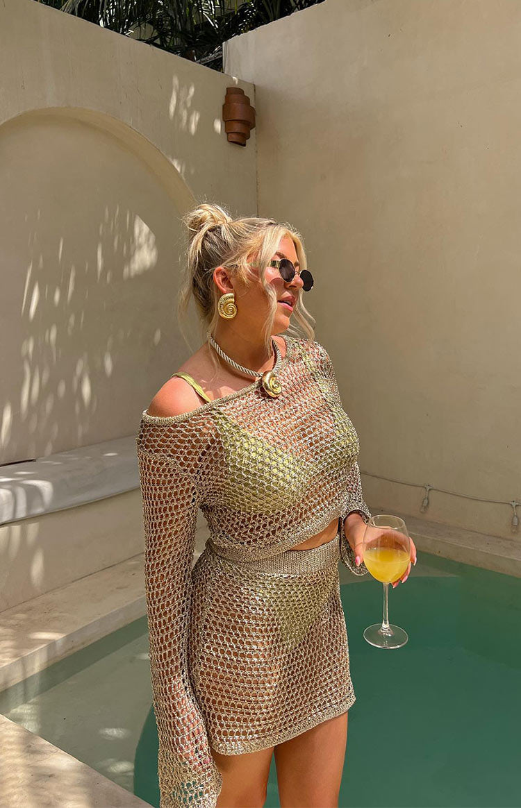 Beginning Boutique Wild Thoughts Gold Metallic Knit Top gold metallic open knit off-shoulder long sleeve cropped top