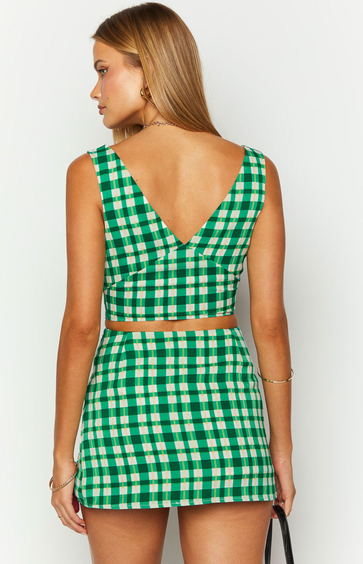 Rear view of a green and cream check mini skirt with a fitted A-line silhouette