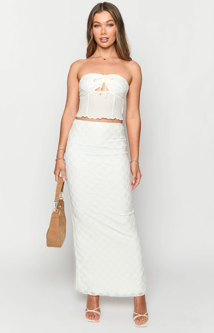 White maxi skirt with a subtle diamond textured pattern and a sleek fitted silhouette