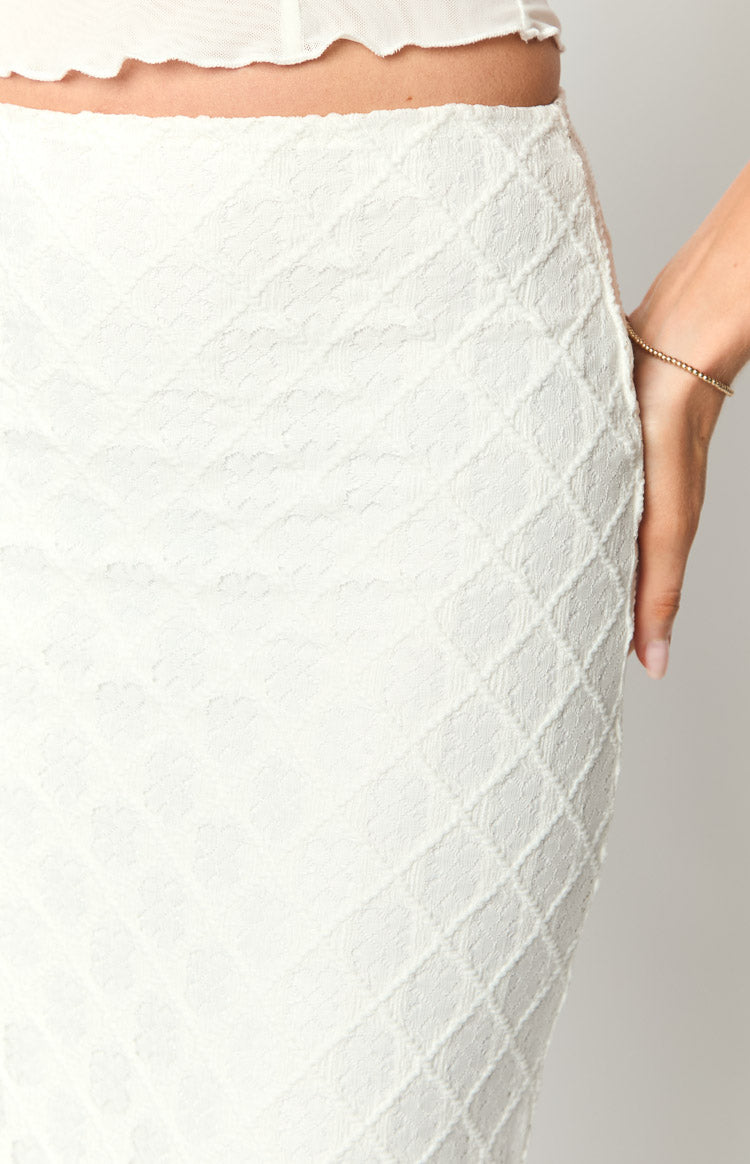 Close-up of the white maxi skirt's textured fabric with a raised diamond pattern