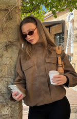 Brown oversized suedette jacket with a funnel neck and two chest flap pockets