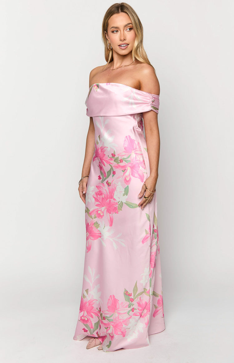 Angled view of the pink floral maxi dress showing the draped off-the-shoulder neckline and ruched short sleeves