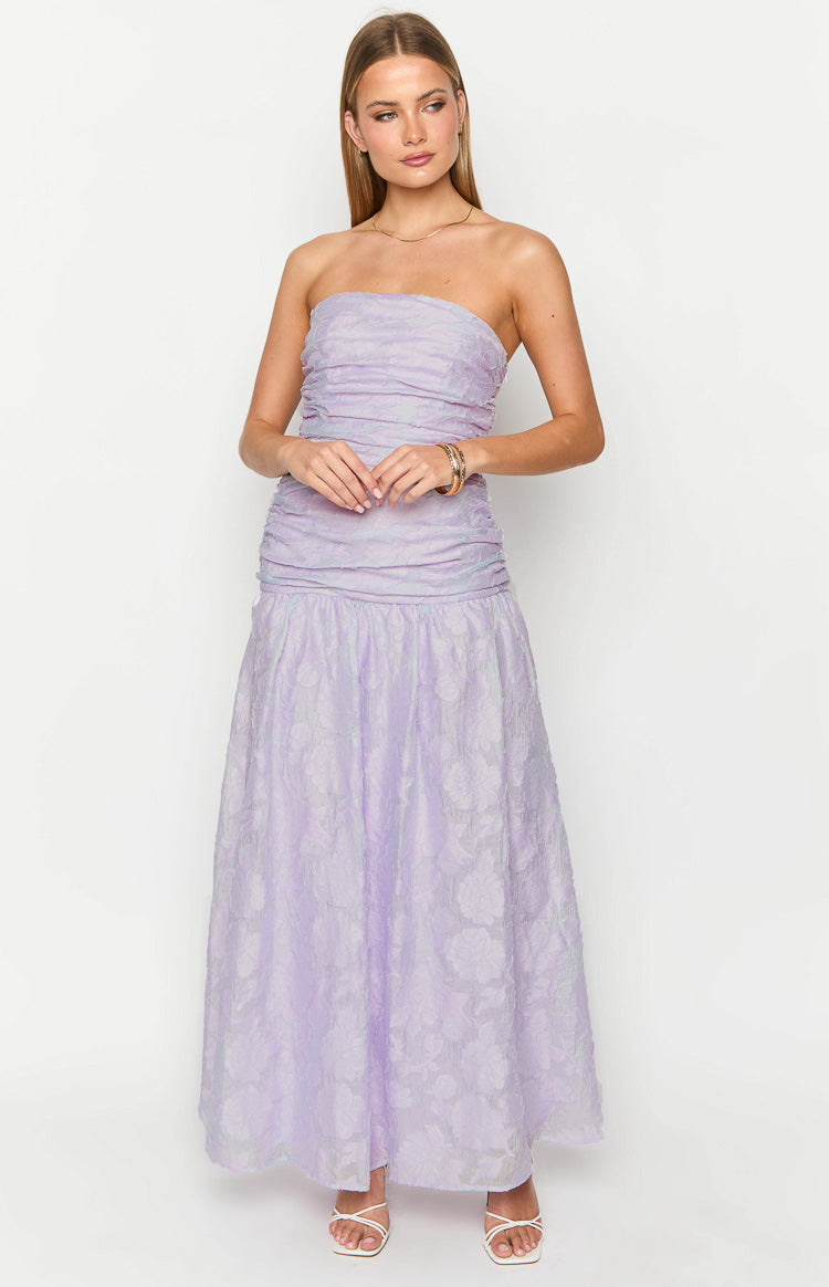 Front view of a lilac strapless maxi dress with a ruched bodice, dropped waist, and a floral textured skirt