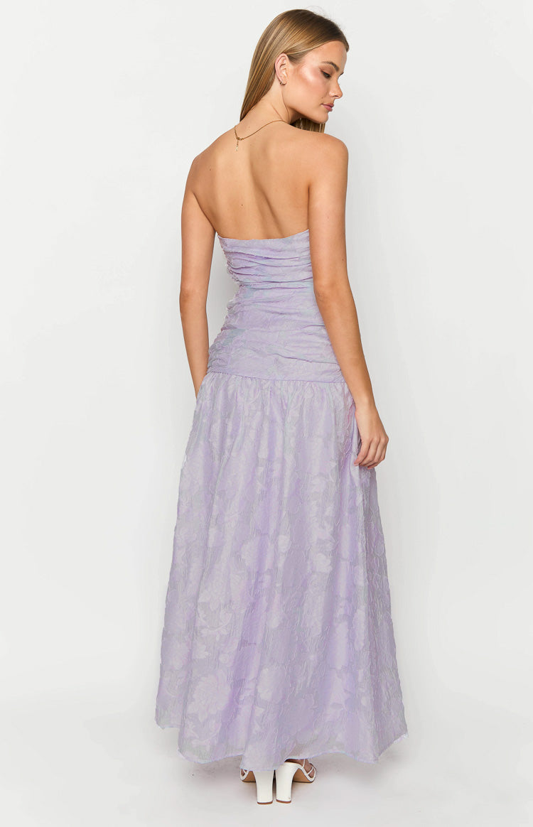 Back view of the lilac strapless maxi dress showing the ruched bodice and drop waist with a textured floral skirt