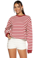 Our model is wearing a long-sleeved crewneck top with horizontal stripes in deep red/burgundy and off-white. This top features a solid deep red collar and cuffs.