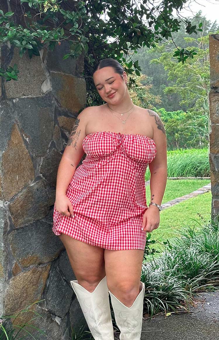 Red gingham strapless mini dress with a tie-front bust and a flowing A-line skirt
