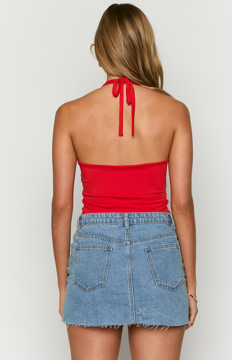 Back view of a red halter neck bodysuit with thin ties fastened at the nape of the neck and an open back