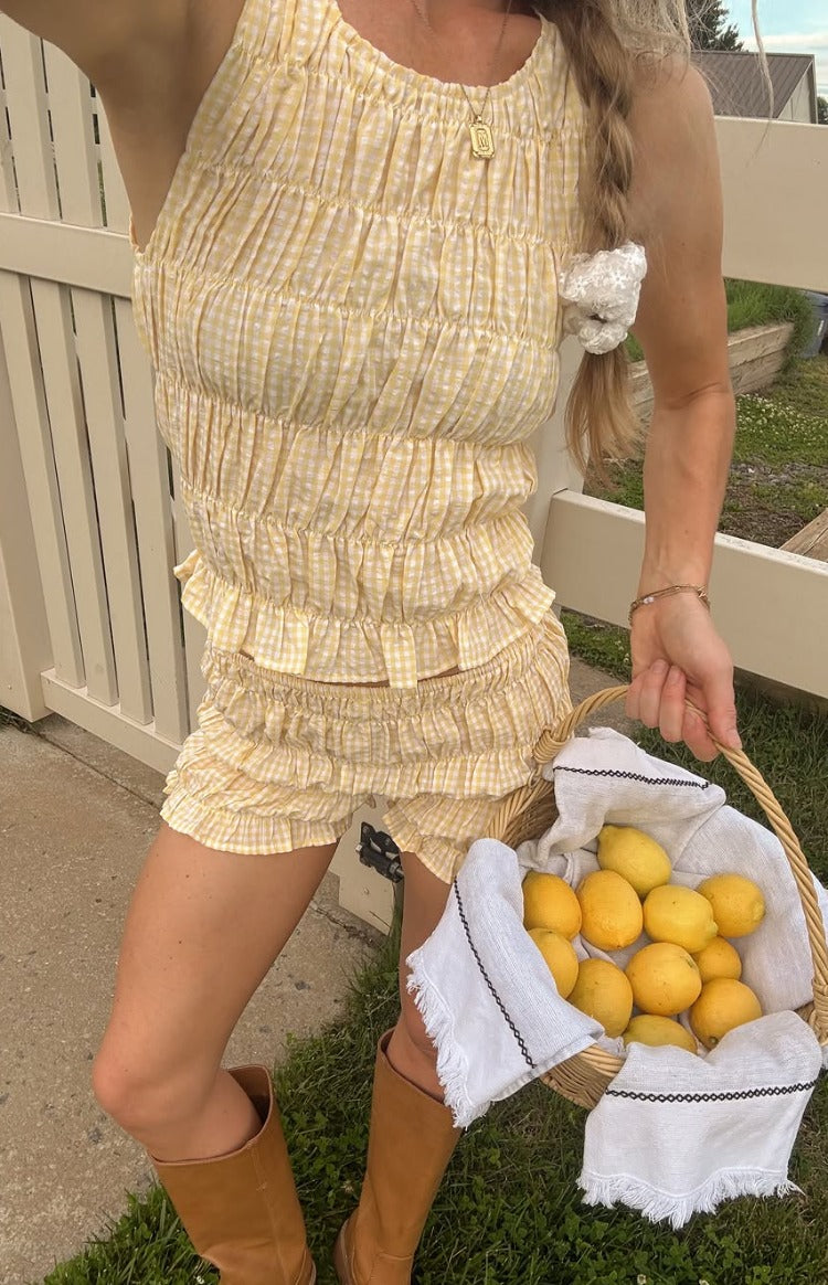 Beginning Boutique Tango Yellow Top yellow and white gingham shirred tank top with a ruffled hem