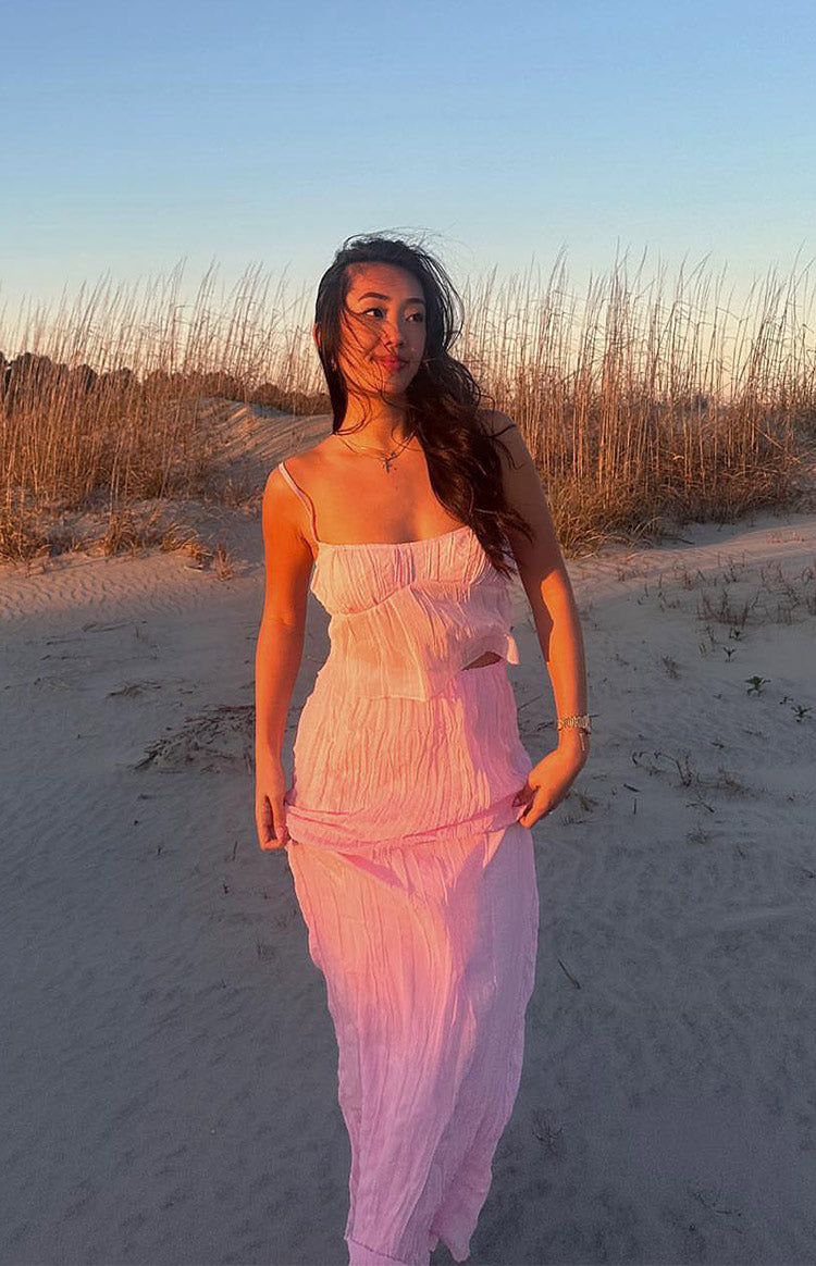 Pink crinkled cami top with a square neckline and thin spaghetti straps, showing its relaxed fit