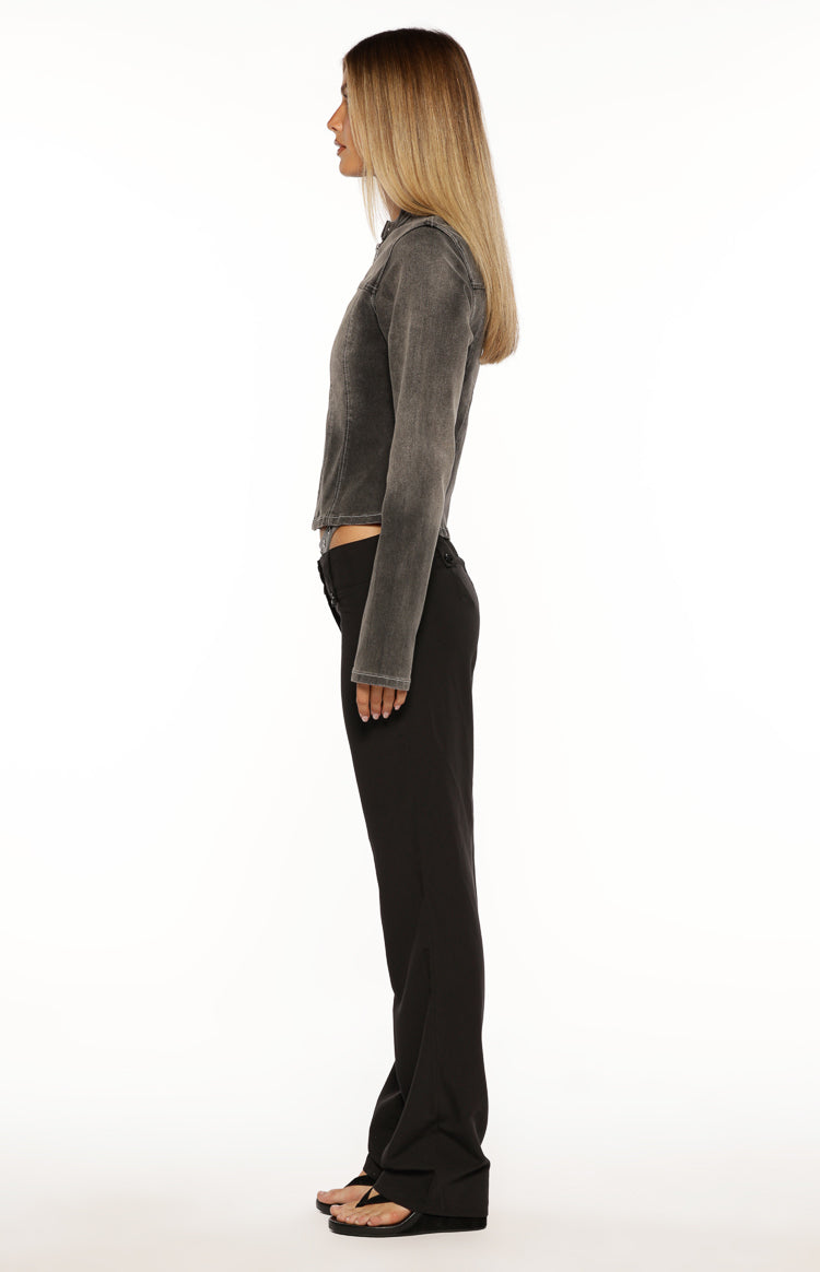 Side view of black low waist pants with a straight leg and relaxed fit, showing the low-rise waistline