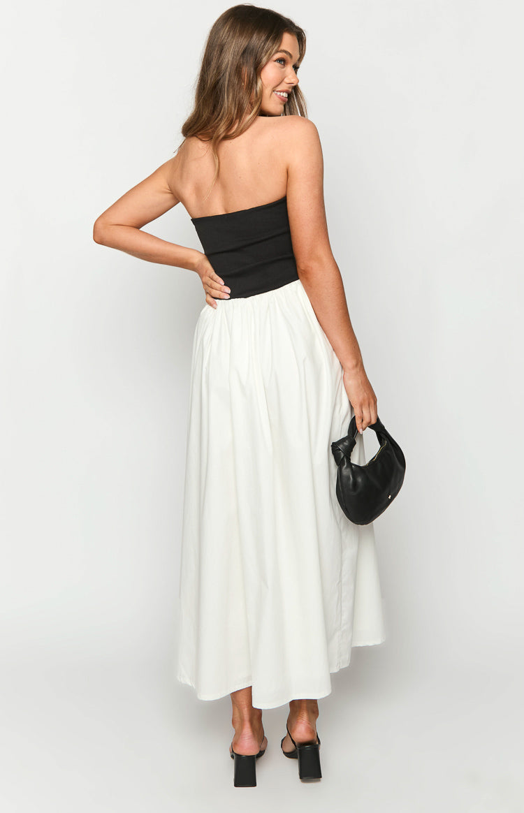 Side-rear view of the black strapless bodice and white gathered skirt of the maxi dress