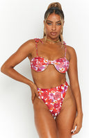 Side-rear view of high-waisted pink floral bikini bottoms with a cheeky cut