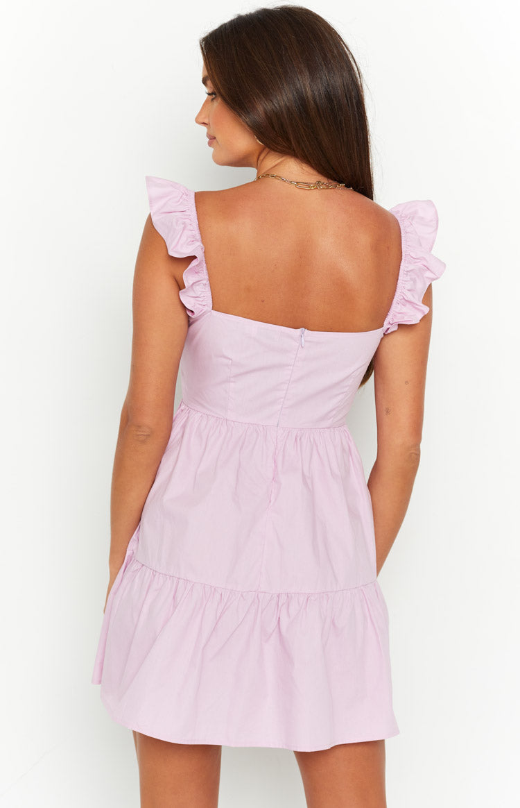 Rear view of a pink tiered mini dress with ruffled shoulder straps and a back zipper