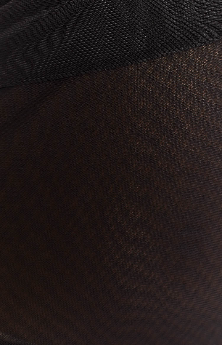 Close-up of the sheer black mesh fabric of the mini dress with a contrasting opaque ribbed band