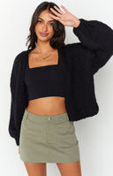 Black chunky knit cardigan with a relaxed, oversized fit and thick sleeves