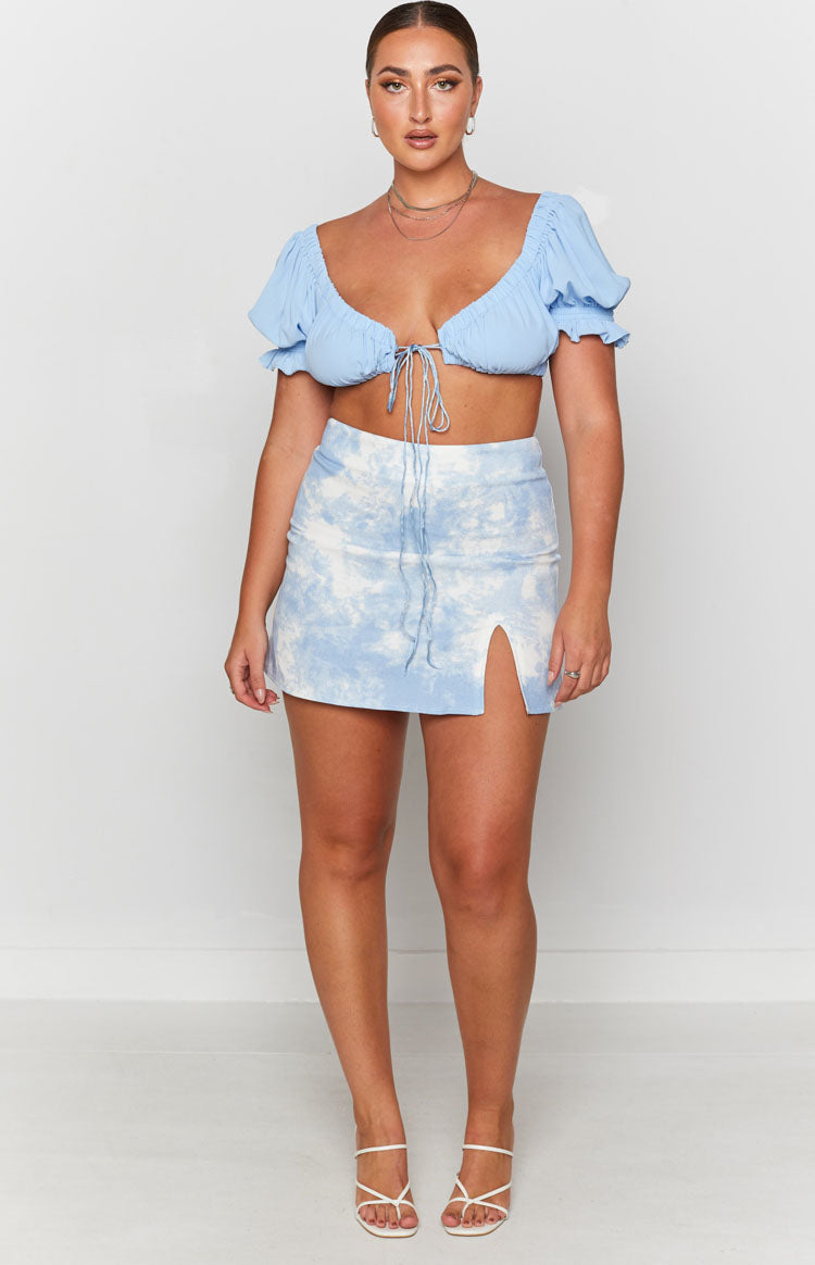 Light blue and white tie-dye denim mini skirt with a high waist, front drawstring, and side slit