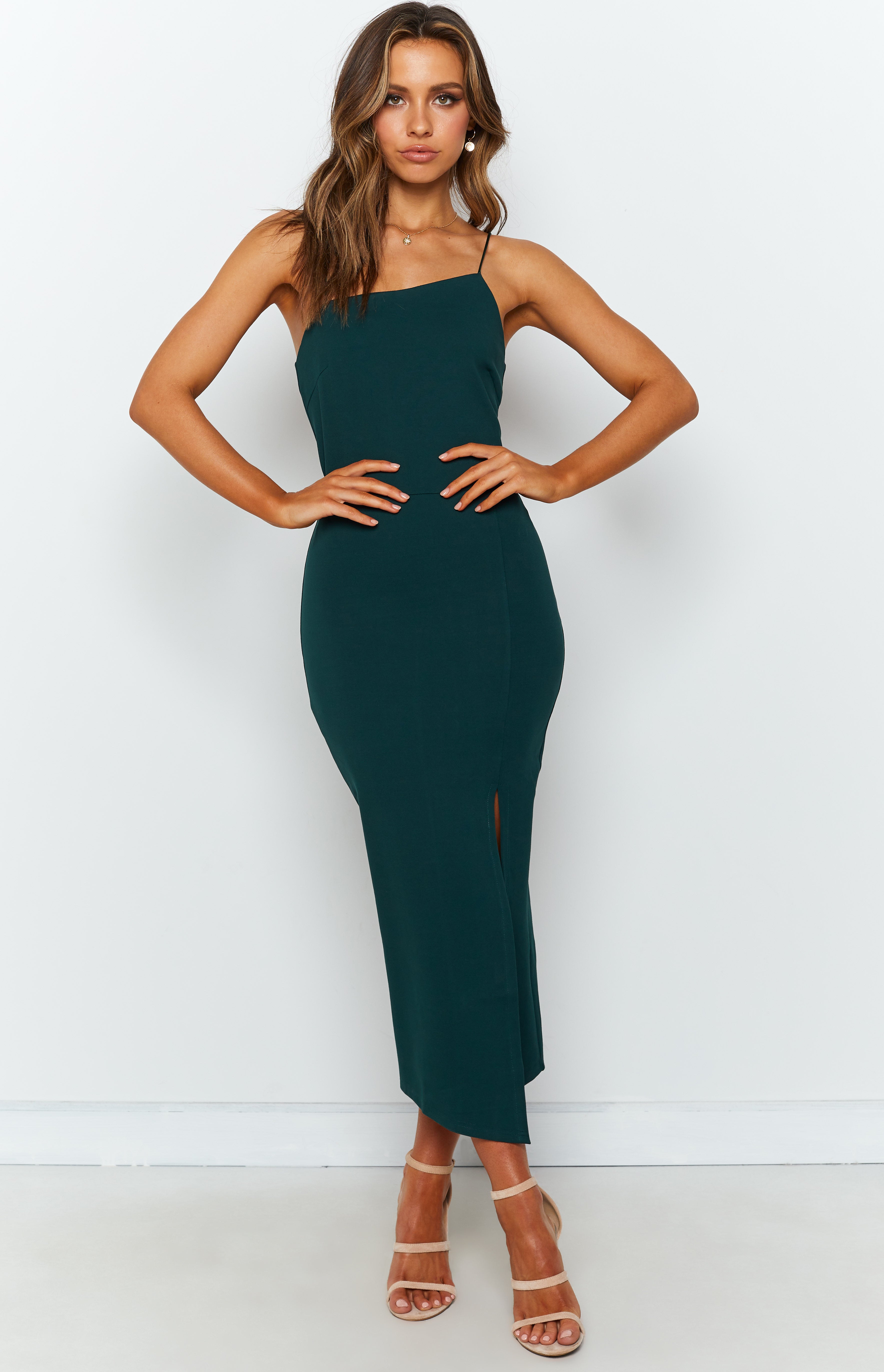 Emerald green midi dress with a straight neckline, thin spaghetti straps, and a fitted bodycon silhouette