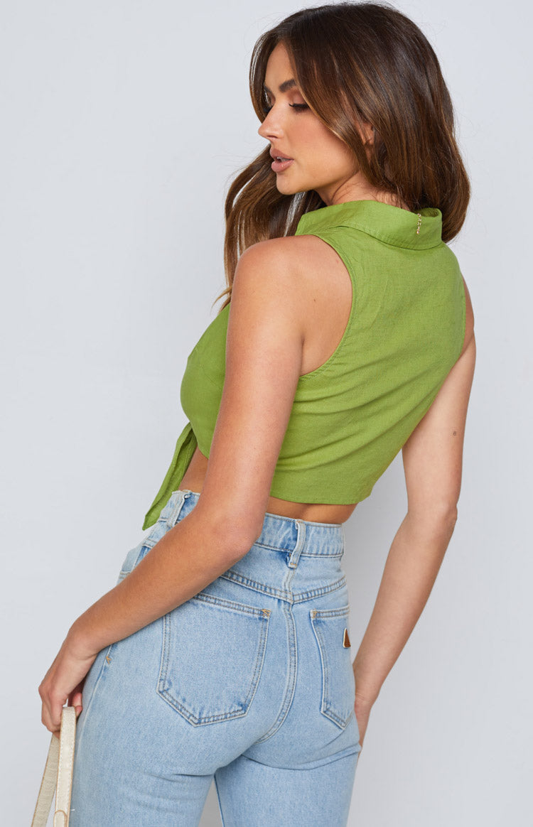 Side view of an olive sleeveless collared tie-up crop shirt with a textured fabric