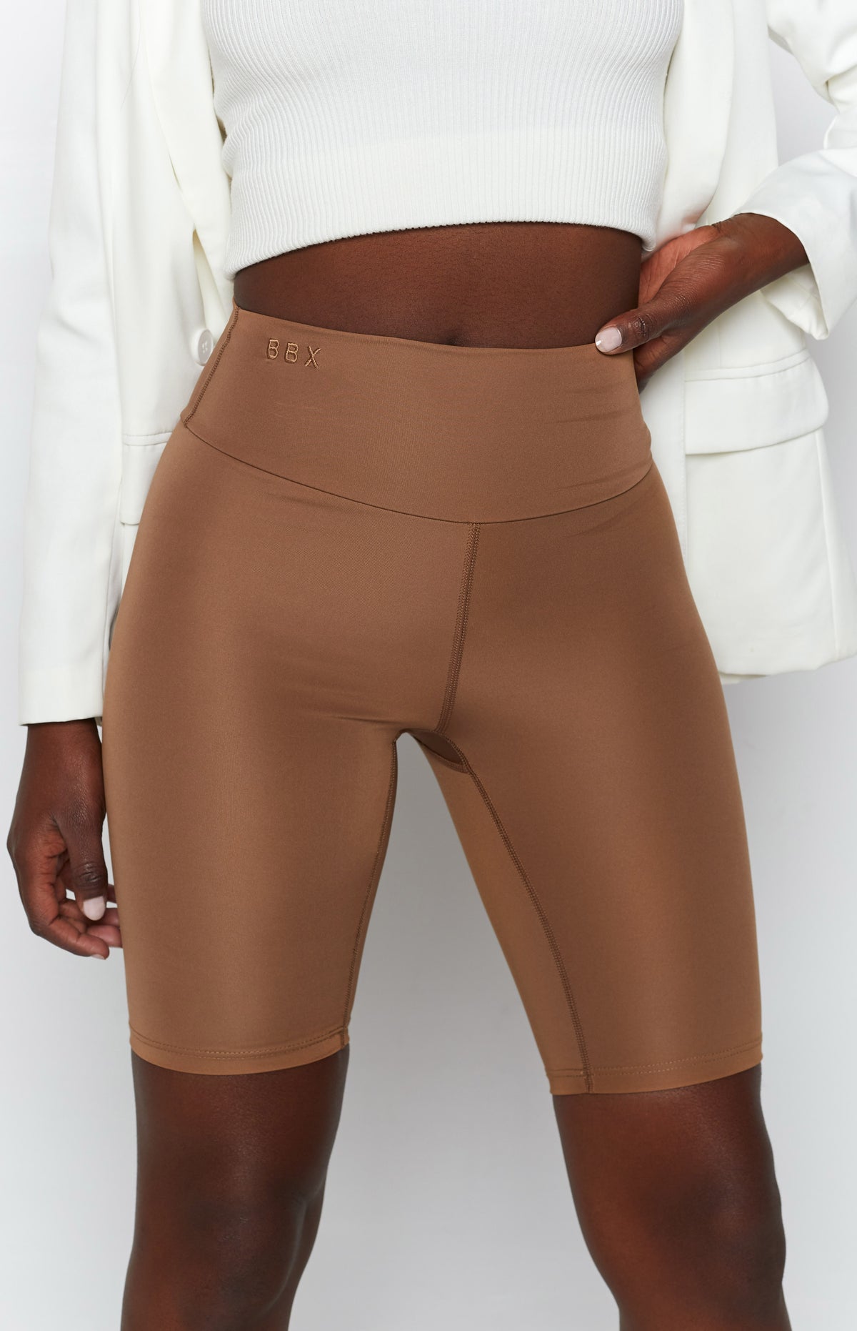 Toffee high-waisted bike shorts with BBX logo embroidery on the waistband and visible flatlock seams