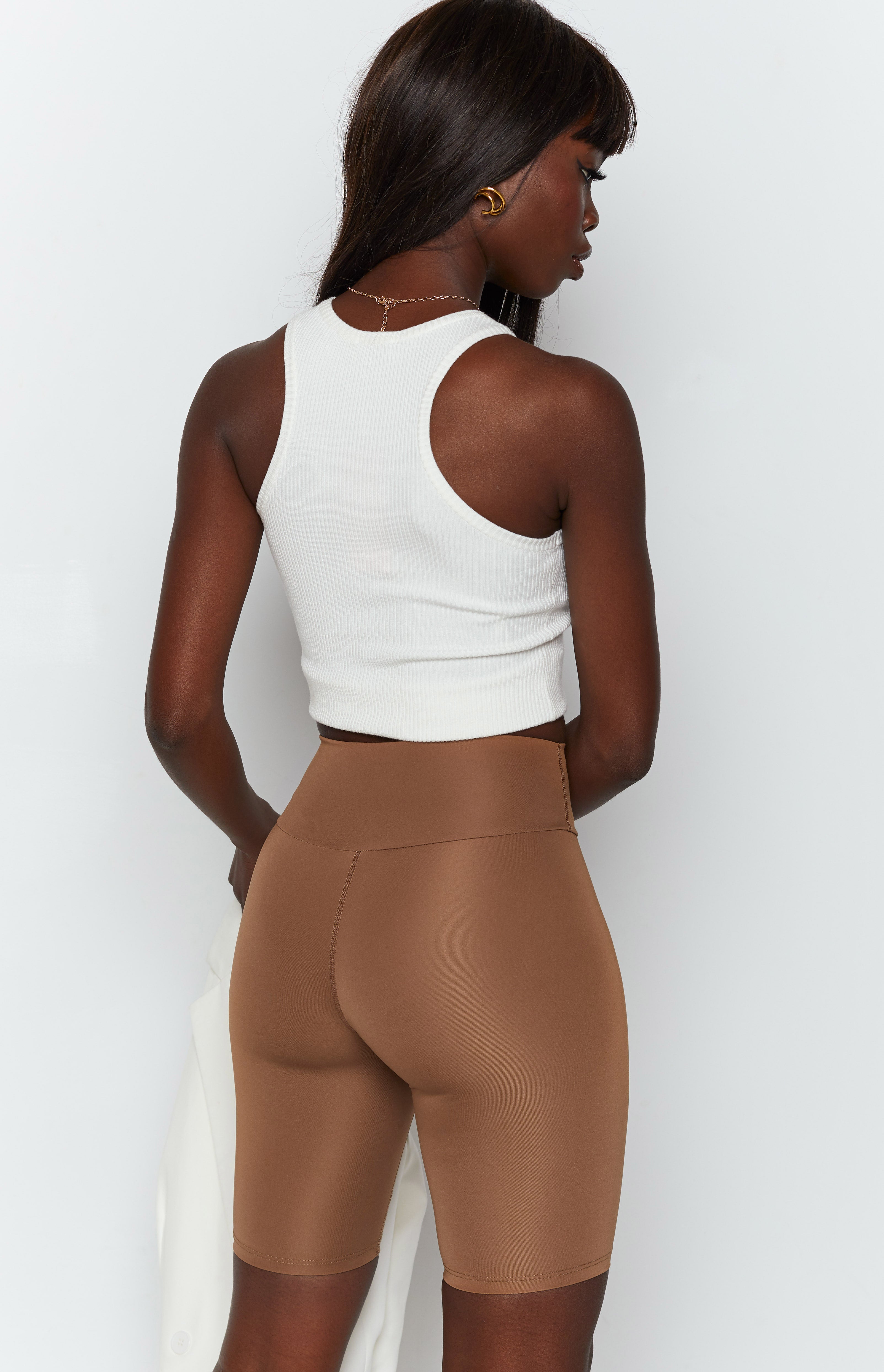 Toffee high-waisted bike shorts with a smooth, stretchy fabric and visible seam details on the back