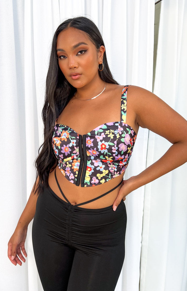 Black floral corset top with a sweetheart neckline, wide straps, and a front hook-and-eye closure