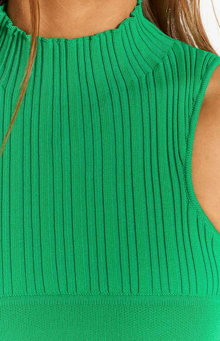 Close-up of the green ribbed knit tank's mock neck with frilled edge, shoulder, and ribbed texture