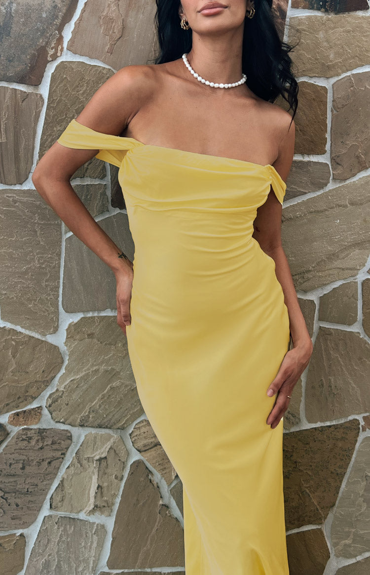 Close-up of the light yellow off-shoulder neckline with draped fabric and fitted bodice