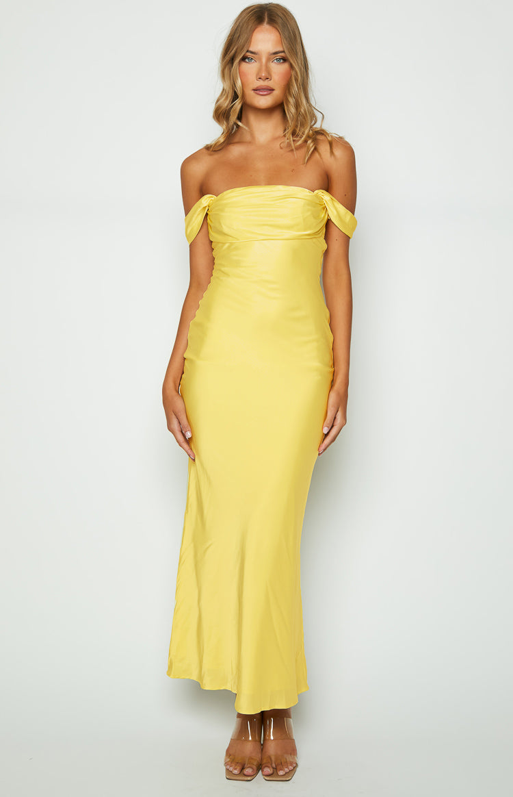 Light yellow off-shoulder maxi dress with a draped bodice and a smooth, flowing skirt