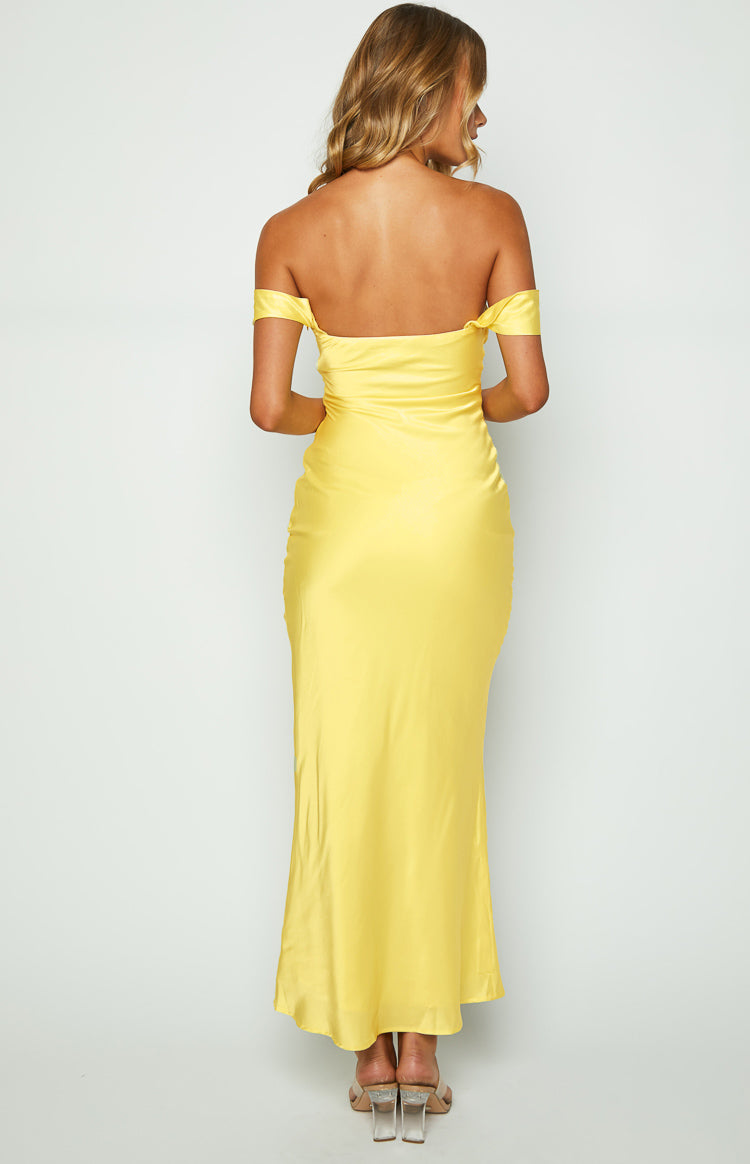 Rear view of a light yellow satin off-shoulder maxi dress with a straight back, short draped sleeves, and fitted bodice