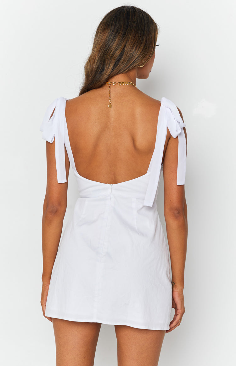 White mini dress with tie-up shoulder straps, a low scoop back, and a visible back zipper
