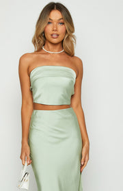 Close-up front view of a sage green satin strapless crop top with a folded neckline