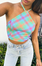 Close-up of the vibrant blue, green, pink, and orange plaid halter top