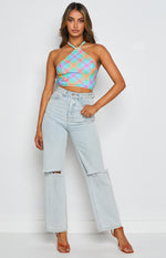 Front view of a blue pink orange and green plaid halter neck crop top with gold chain detail