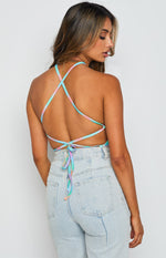Rear view showing the open back with criss-cross tie-back straps on a pastel tie-dye halter top