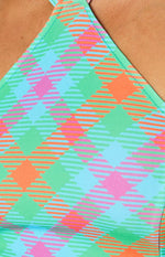 Detail of the vibrant blue, green, pink, and orange check fabric