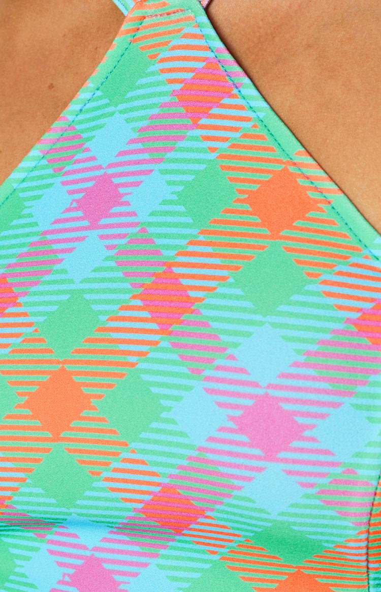Detail of the vibrant blue, green, pink, and orange check fabric