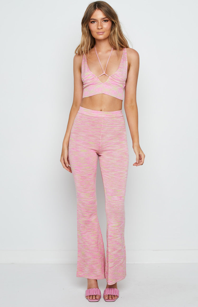 Front view of a pink and yellow marl knit crop top with a V-neck and criss-cross halter straps
