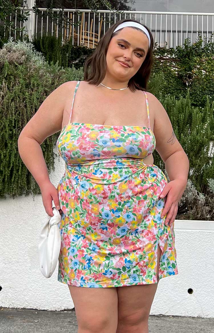 Multi-colour floral print mini dress with straight neckline, thin spaghetti straps, side cutouts, and a side slit