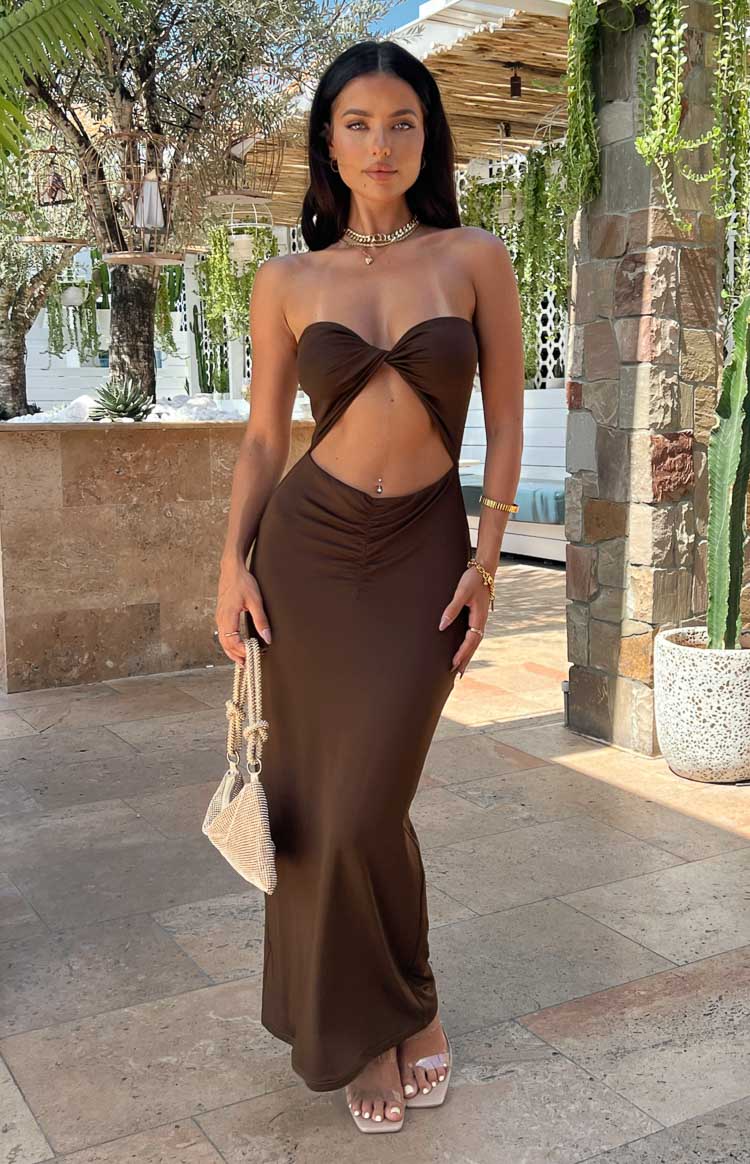 Brown strapless midi dress with a twisted bust, midriff cutout, and ruched detail on the fitted skirt