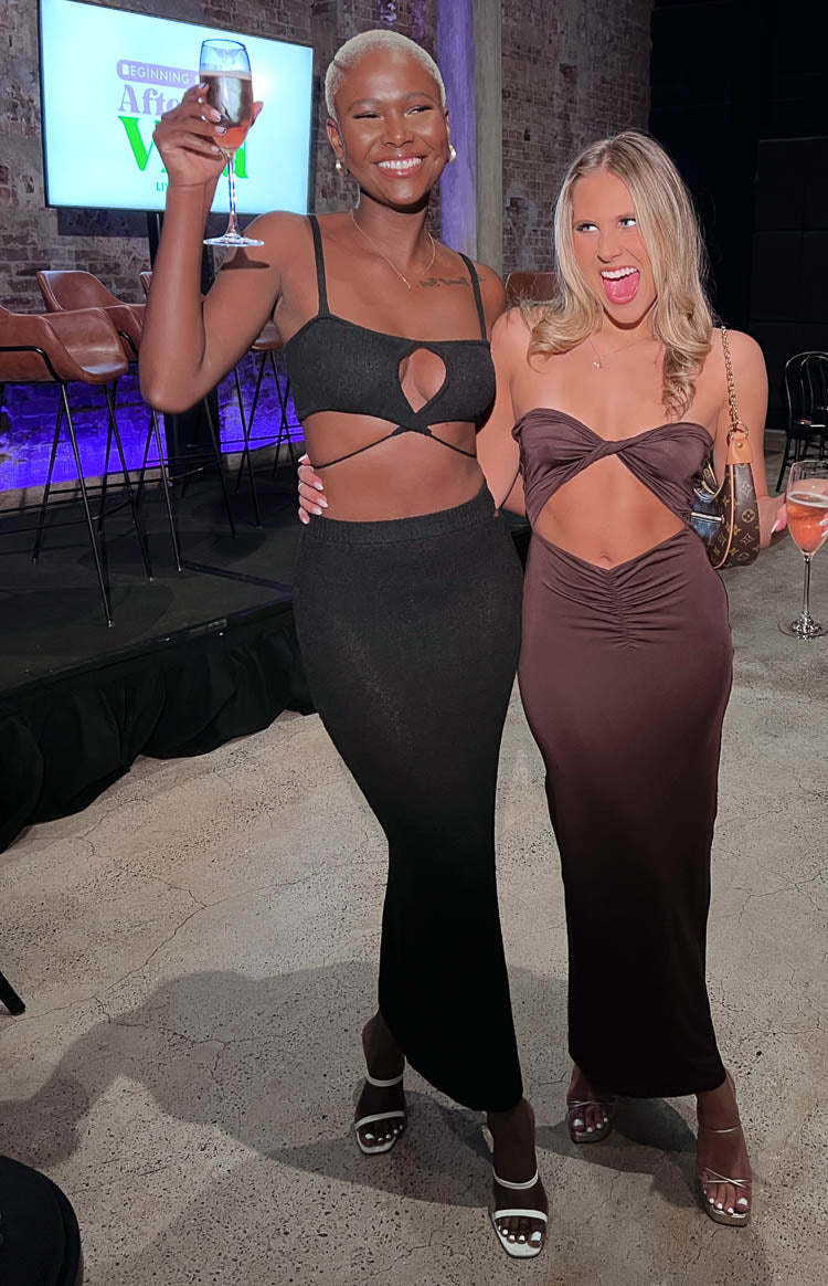 Brown strapless midi dress with twisted bandeau top, midriff cutout, and ruched bodycon skirt