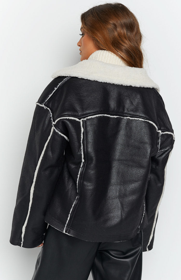 Back view of a black faux leather jacket with white sherpa collar and seam detailing