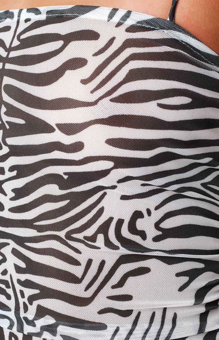 Detail shot showing the black and white zebra print and sheer mesh texture of the mini dress