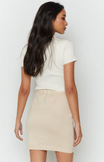 Cream knit mini skirt with an elasticated waistband and fine ribbed texture, back view