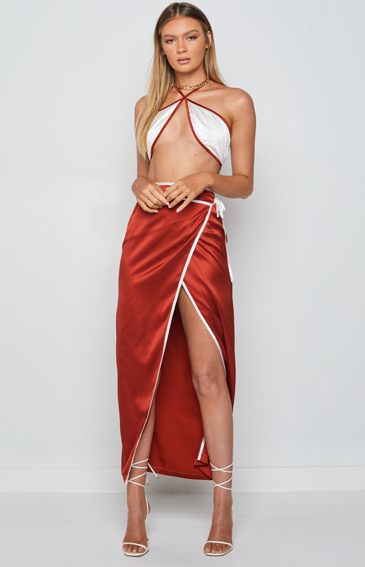 White satin halter crop top with a deep V-neckline and rust-colored trim