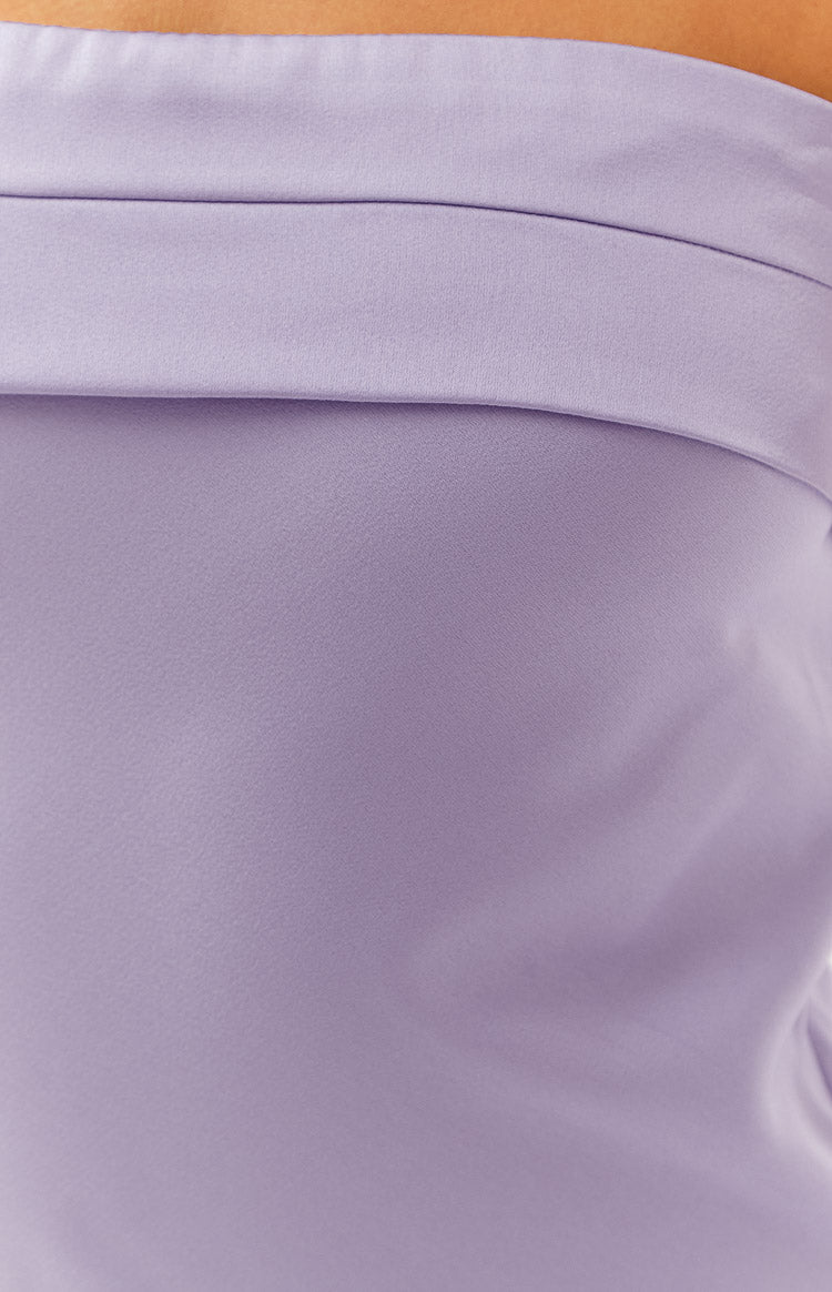 Close-up of the textured lilac fabric with a horizontal folded band detail on the maxi dress