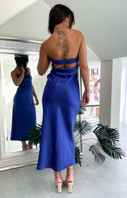 Rear view of a navy satin maxi dress with an open back, ruched elastic band, and side waist cutouts