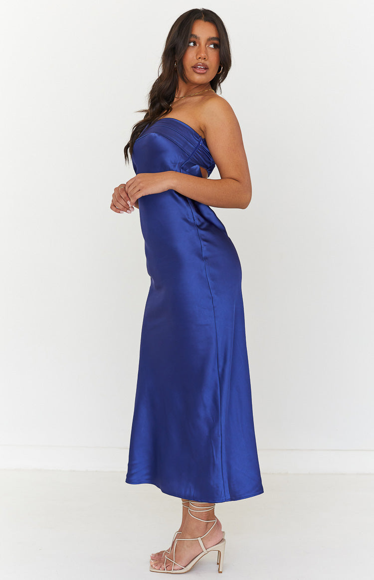 Side view of a navy satin strapless maxi dress with a ruched bust and side cutout
